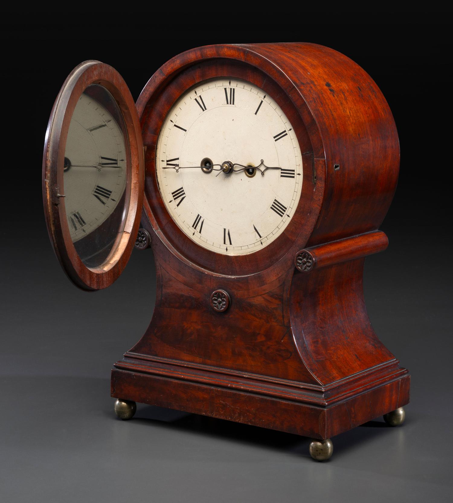 A Federal Carved and Figured Mahogany Balloon-Form Bracket Clock