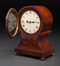 A Federal Carved and Figured Mahogany Balloon-Form Bracket Clock