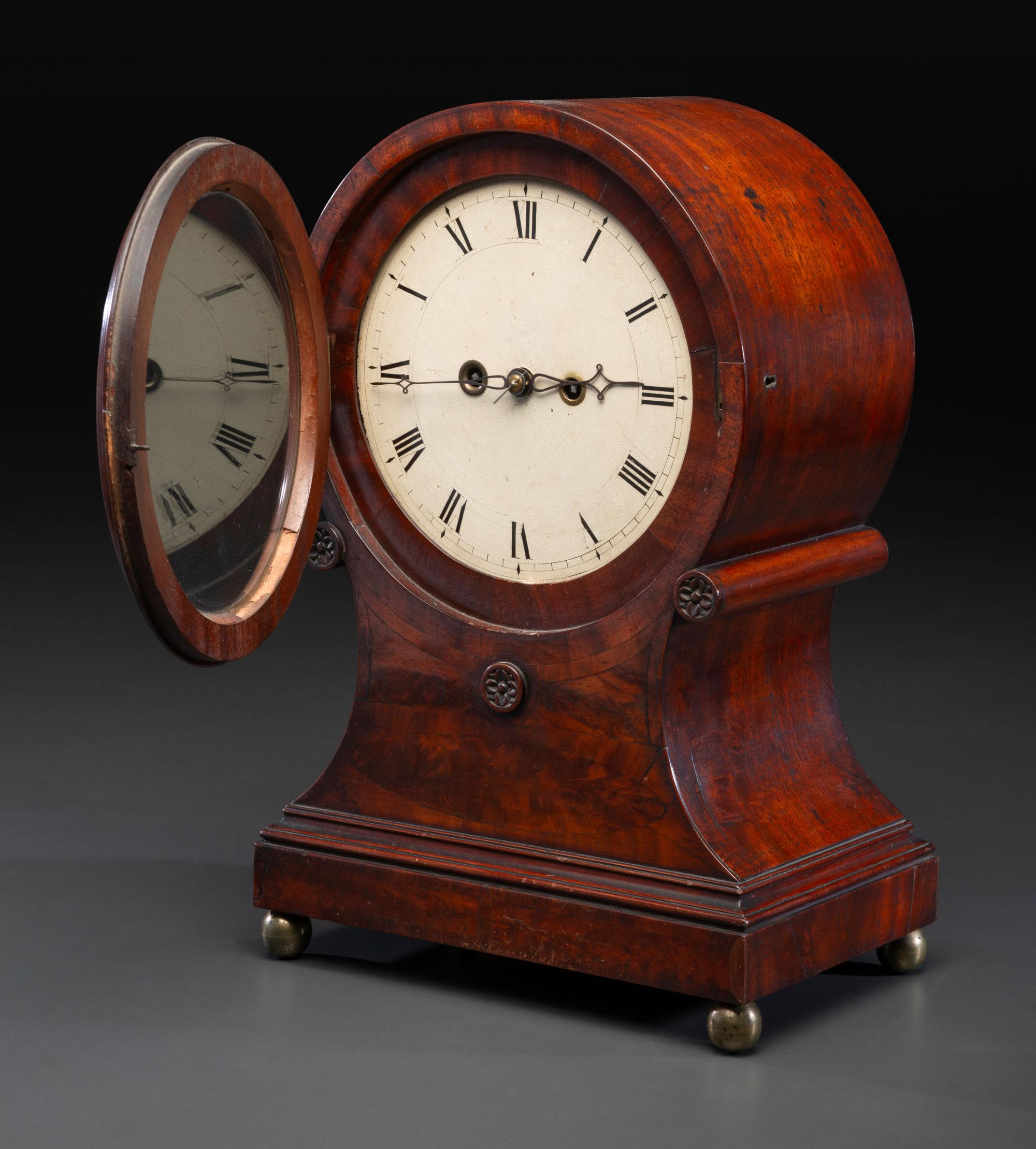 A Federal Carved and Figured Mahogany Balloon-Form Bracket Clock