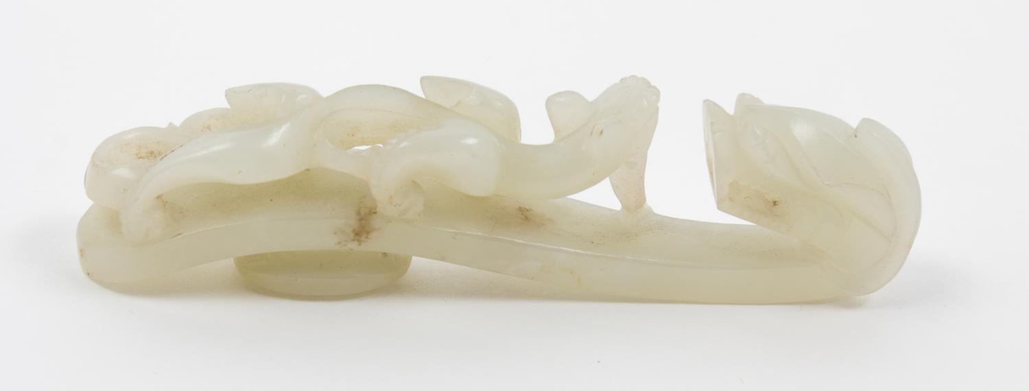 A Pale Celadon Jade Dragon Belt Hook Length 3 7/8 inches.