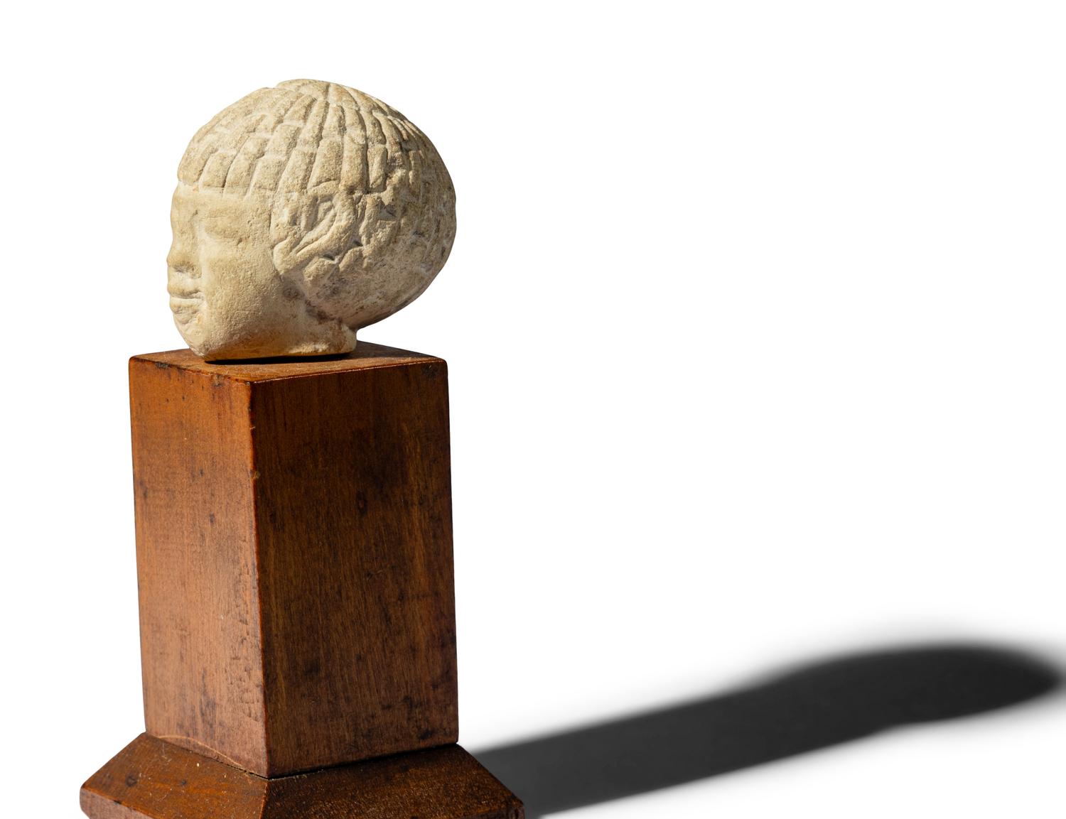 An Egyptian Limestone Head of a Nubian