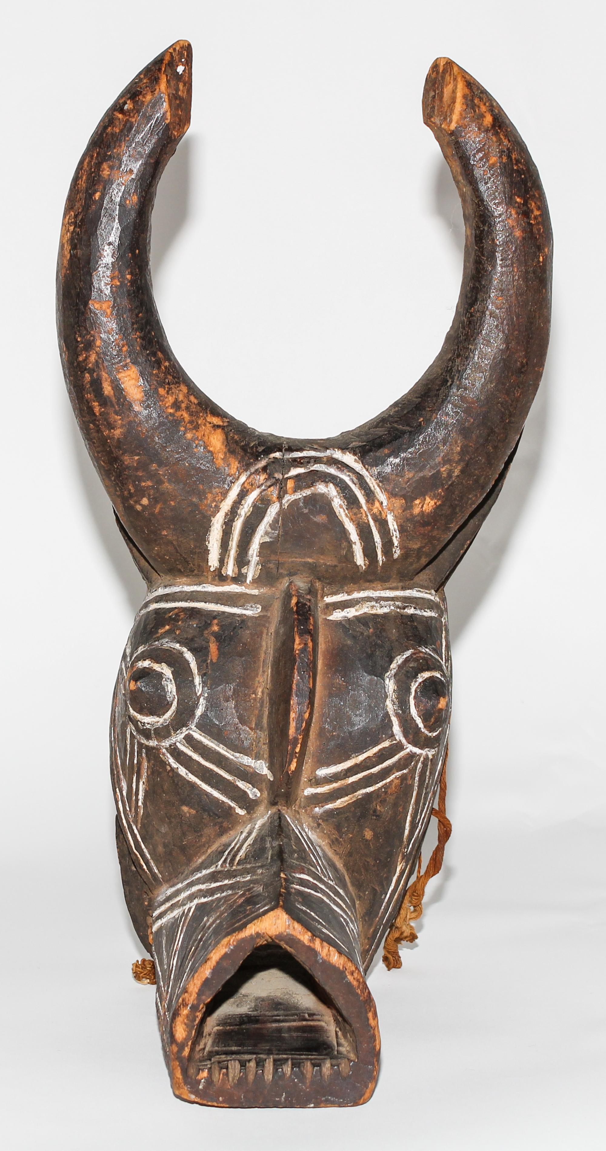 A Bobo White Pigmented Buffalo Mask. Height 18 inches.