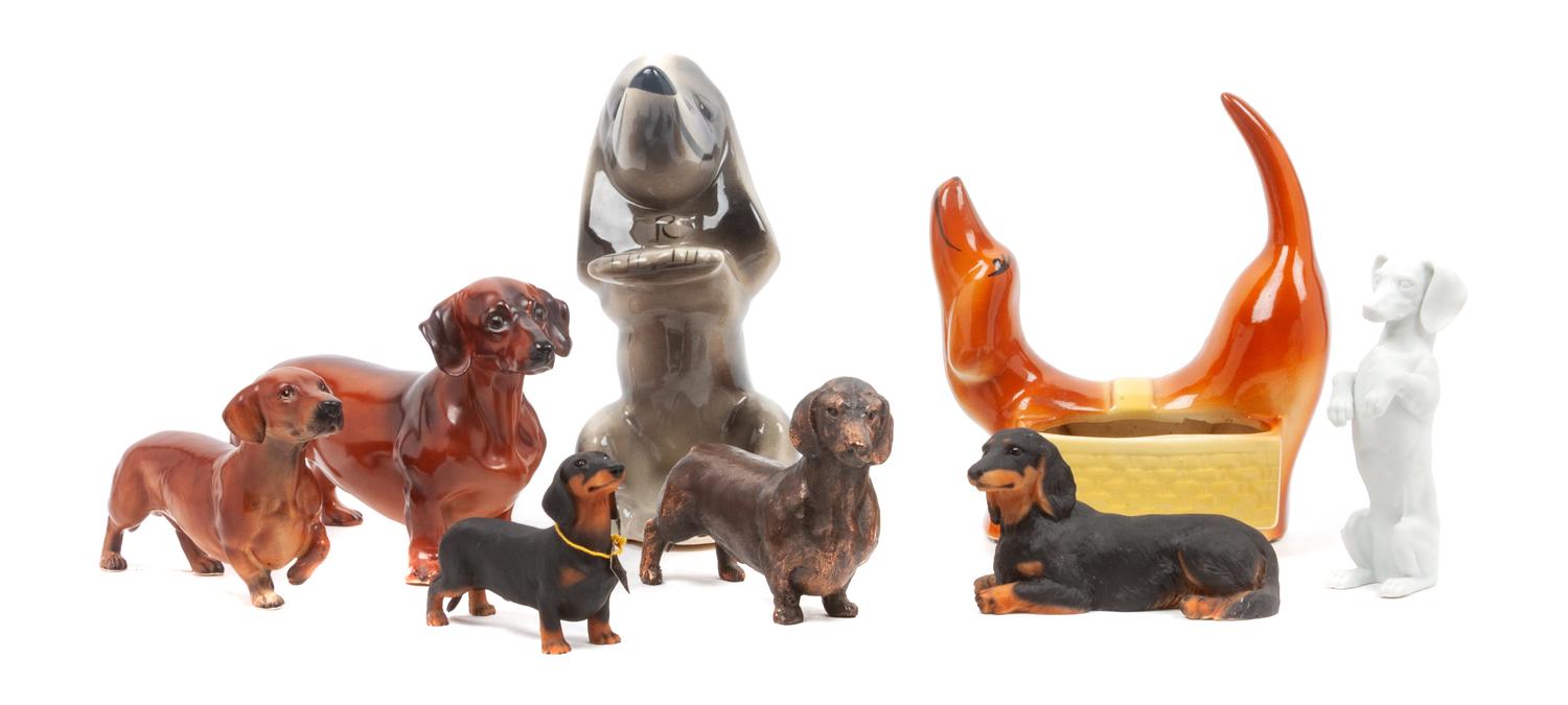 A Group of Eight Dachshund Figures Height of tallest 8 1/4 inches.