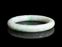 A Chinese Carved Apple Green and White Jadeite Bangle