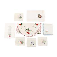 A Collection of Table Linens and Strawberry-Themed Articles