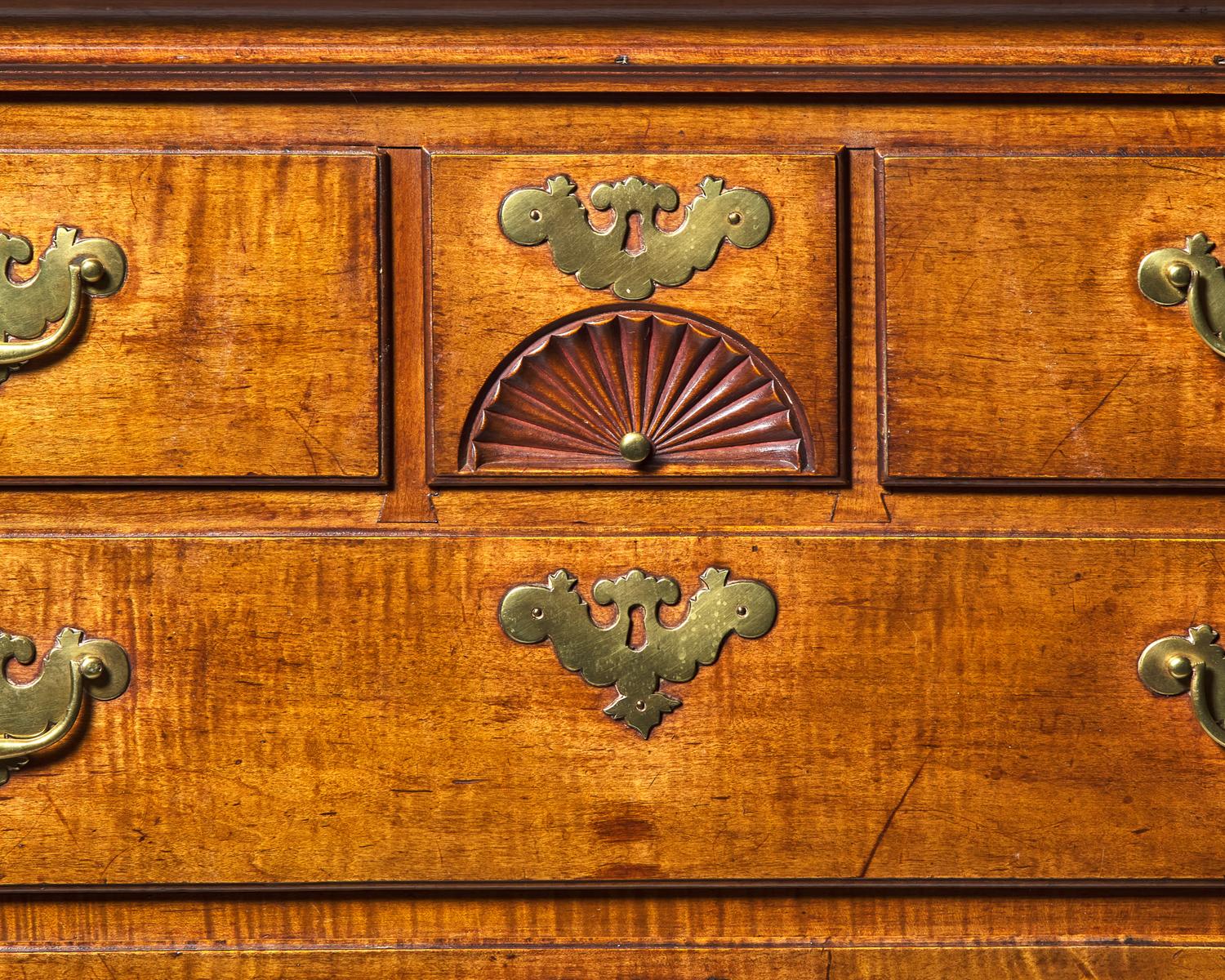 A Queen Anne Carved Figured Maple and Birch Flat-Top High Chest of Drawers