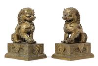 A Pair of Chinese Bronze Fu Lions and Stands 18TH/19TH CENTURY Height overall 14 1/2 inches. — 18TH/19TH CENTURY