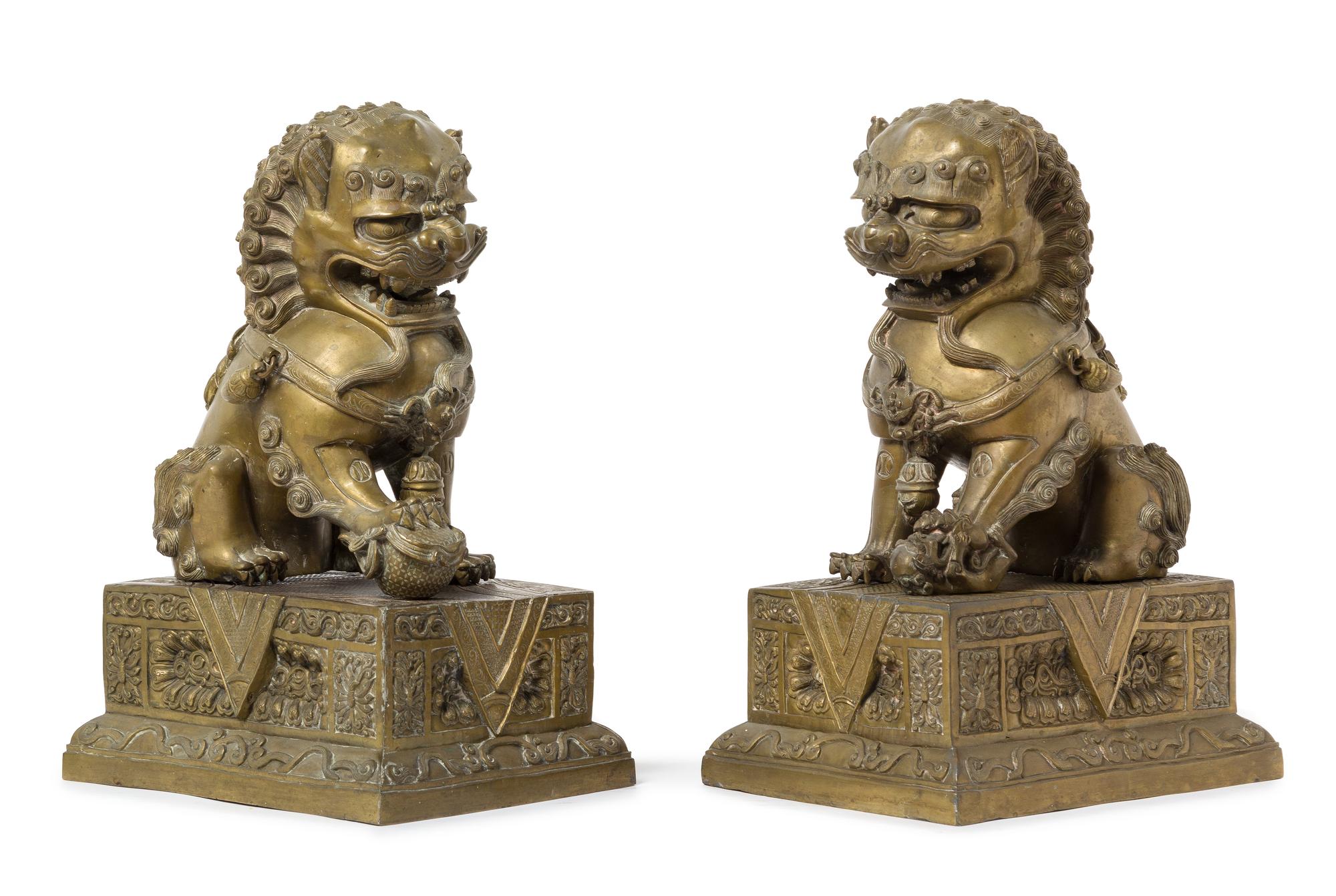 A Pair of Chinese Bronze Fu Lions and Stands 18TH/19TH CENTURY Height overall 14 1/2 inches. — 18TH/19TH CENTURY