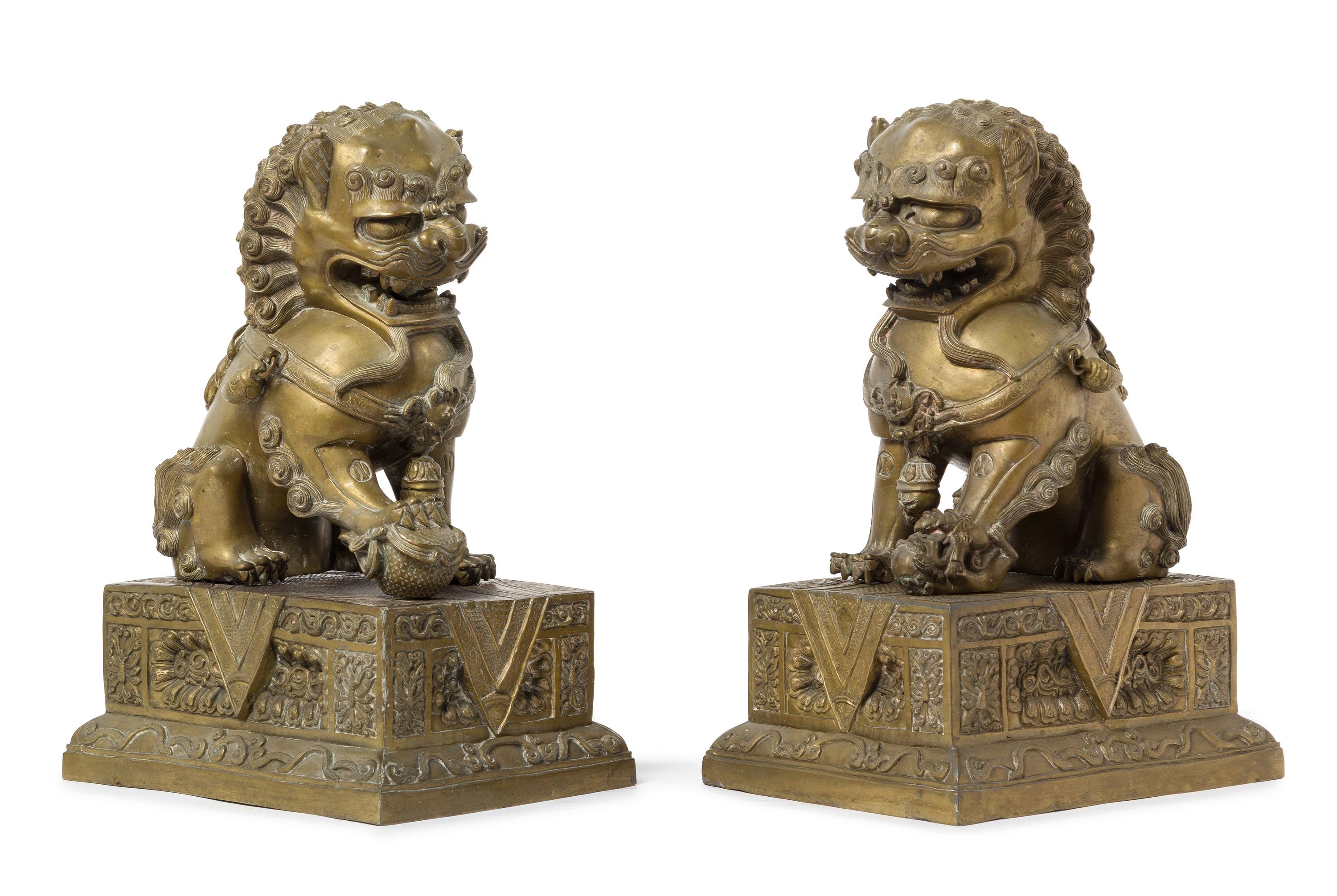 A Pair of Chinese Bronze Fu Lions and Stands 18TH/19TH CENTURY Height overall 14 1/2 inches. — 18TH/19TH CENTURY