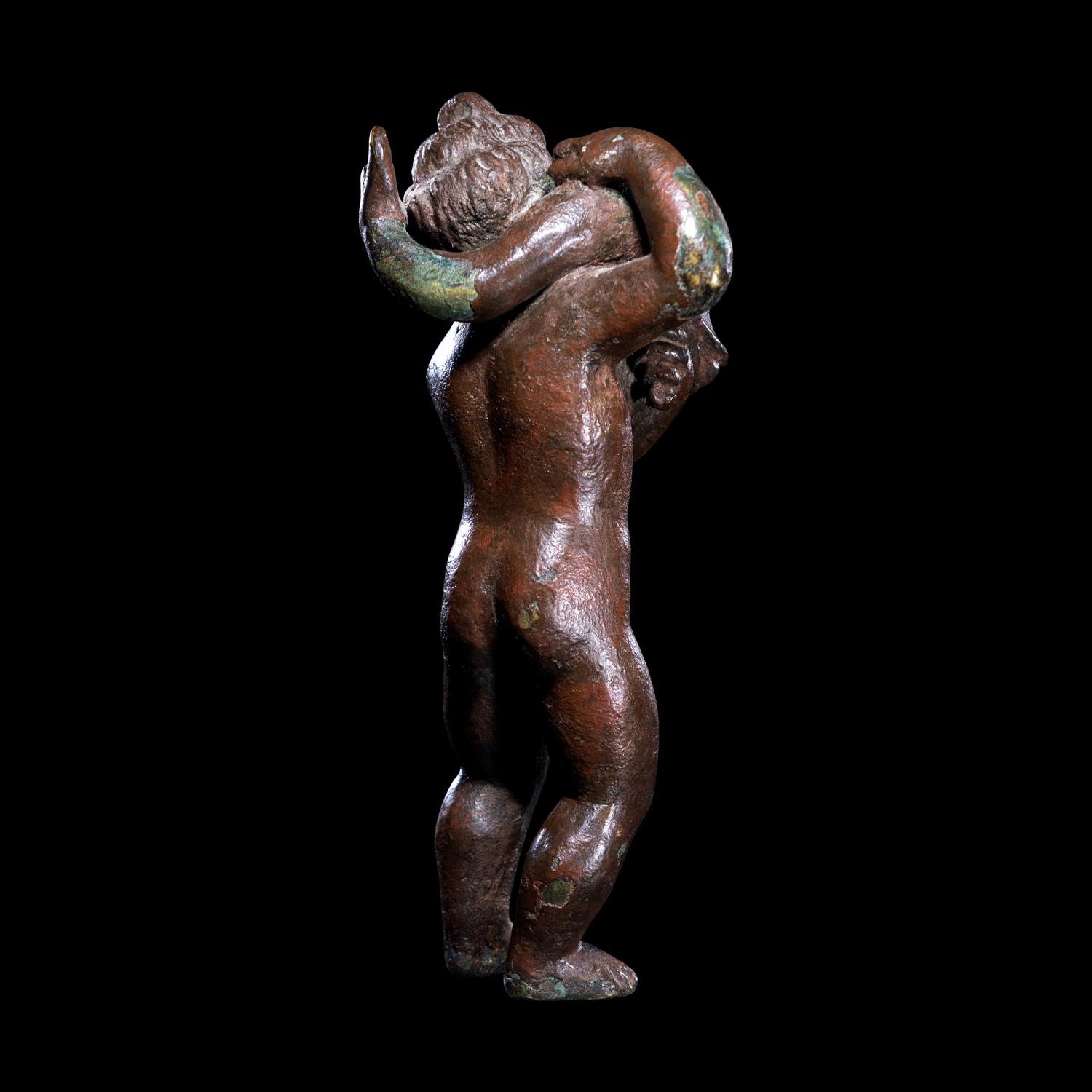 A Roman Bronze Eros with a Dolphin