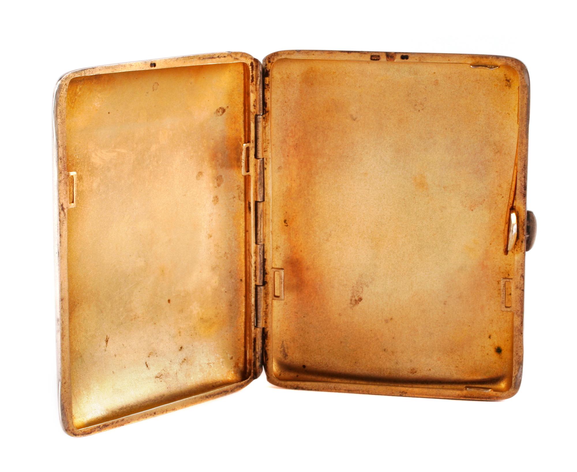 A German Enameled Silver Cigarette Case, Late 19th/Early 20th Century, the lid decorated with a nude figure bathing in a brook.