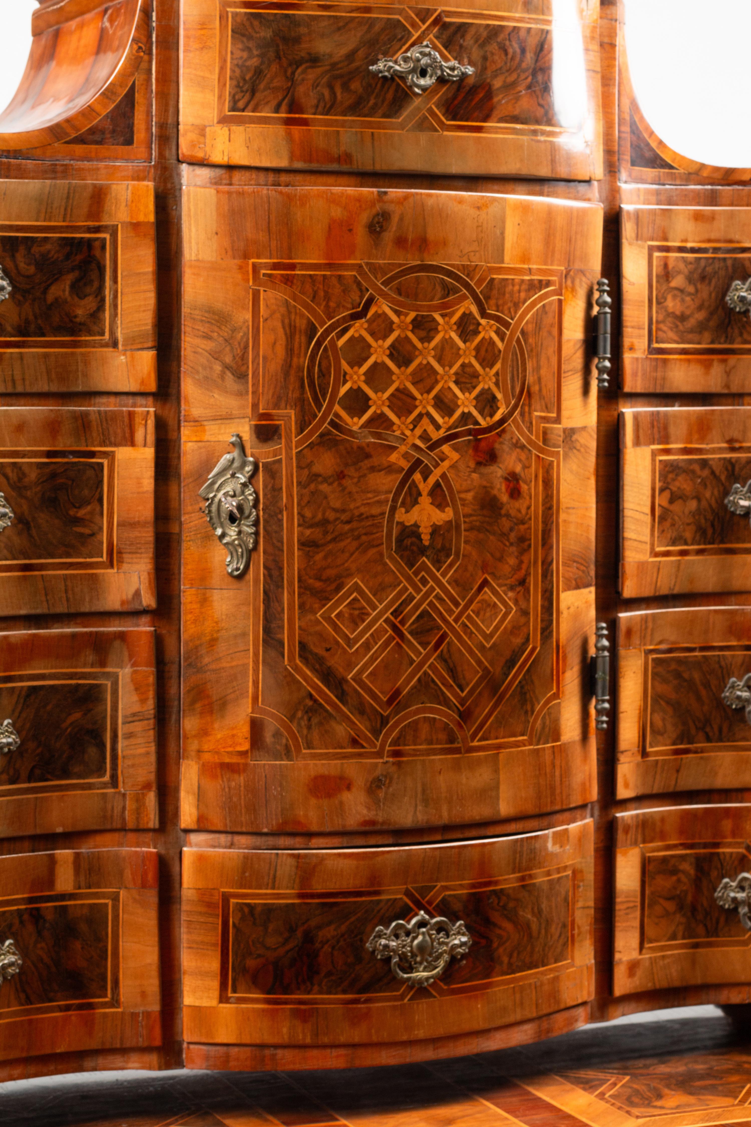 A German or Austrian Walnut and Marquetry Tabernacle Cabinet and Chest of Drawers