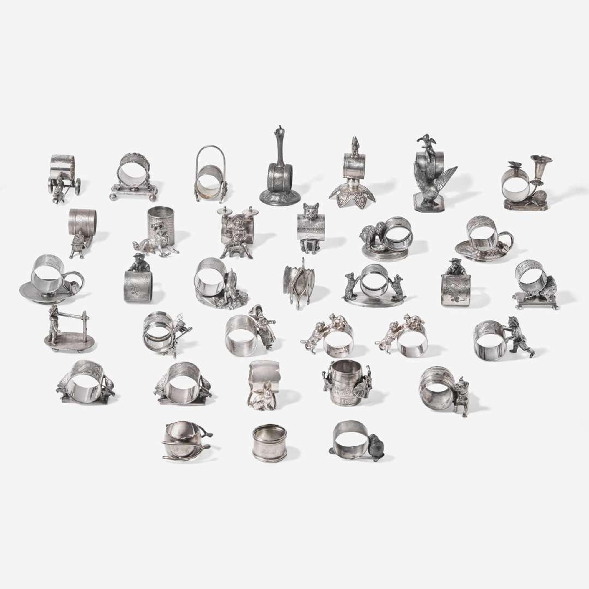 A collection of thirty-four Victorian silverplated and pewter napkin holders Various American and Canadian makers, Connecticut, Massachusetts, and Ontario, late 19th century