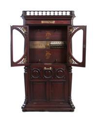 A Orchestral Regina Upright Music Box, Height 77 1/2 x width 42 3/4 x depth 17 inches.