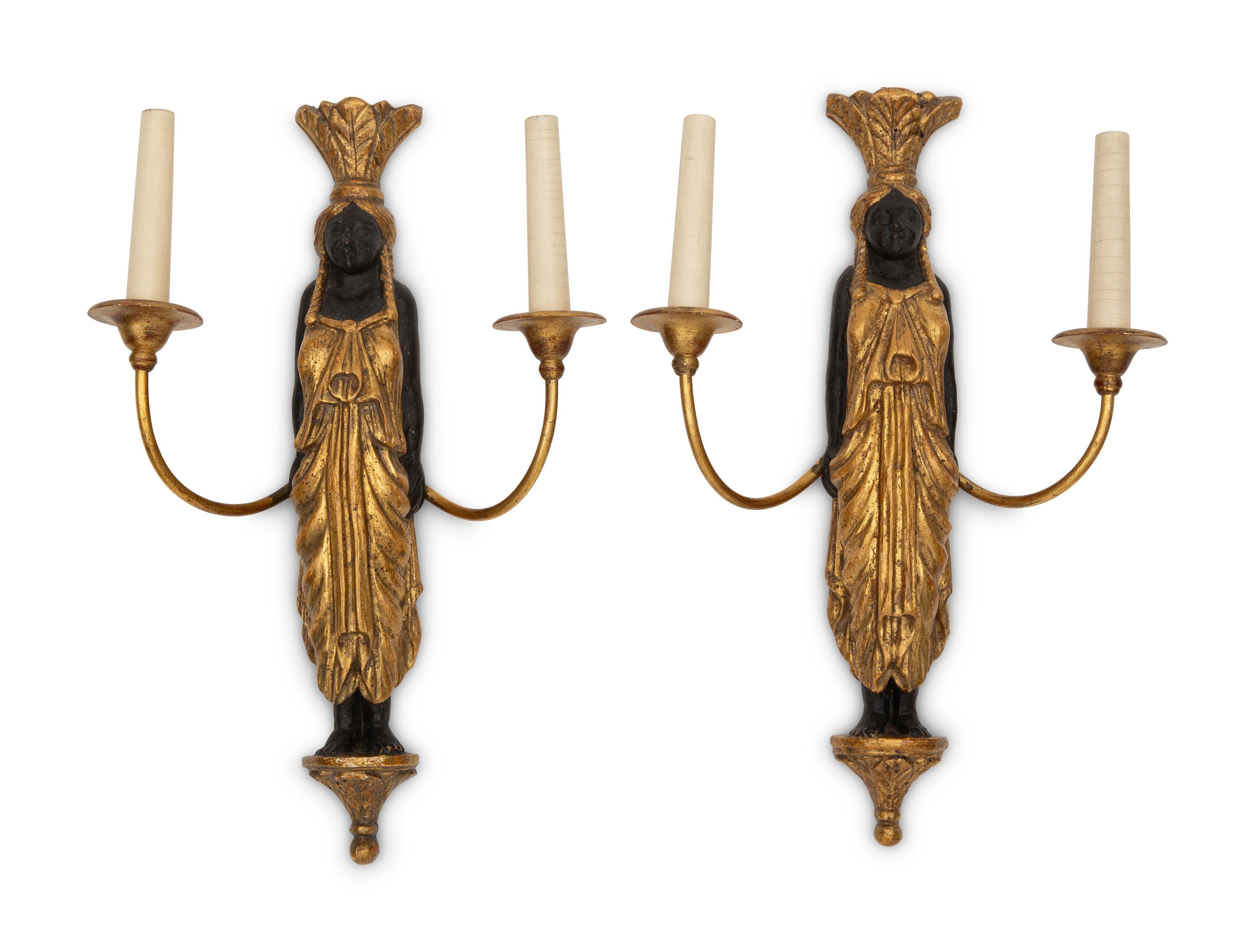 A Pair of Continental Empire Style Ebonized and Parcel Gilt Two-Light Figural Sconces