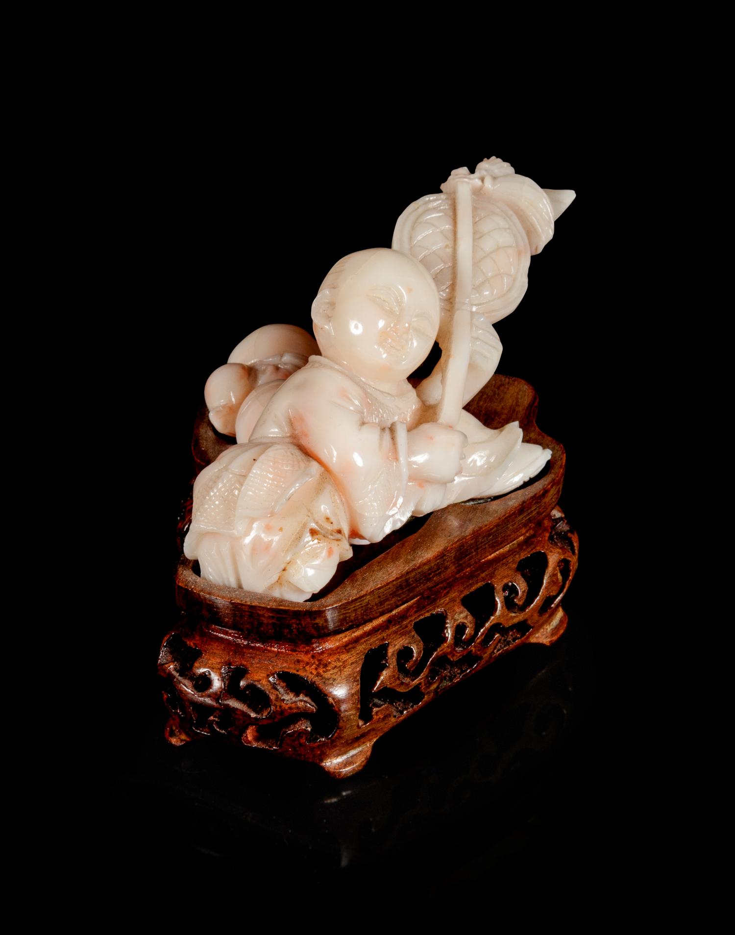 A Pink Coral Carving of a Boy