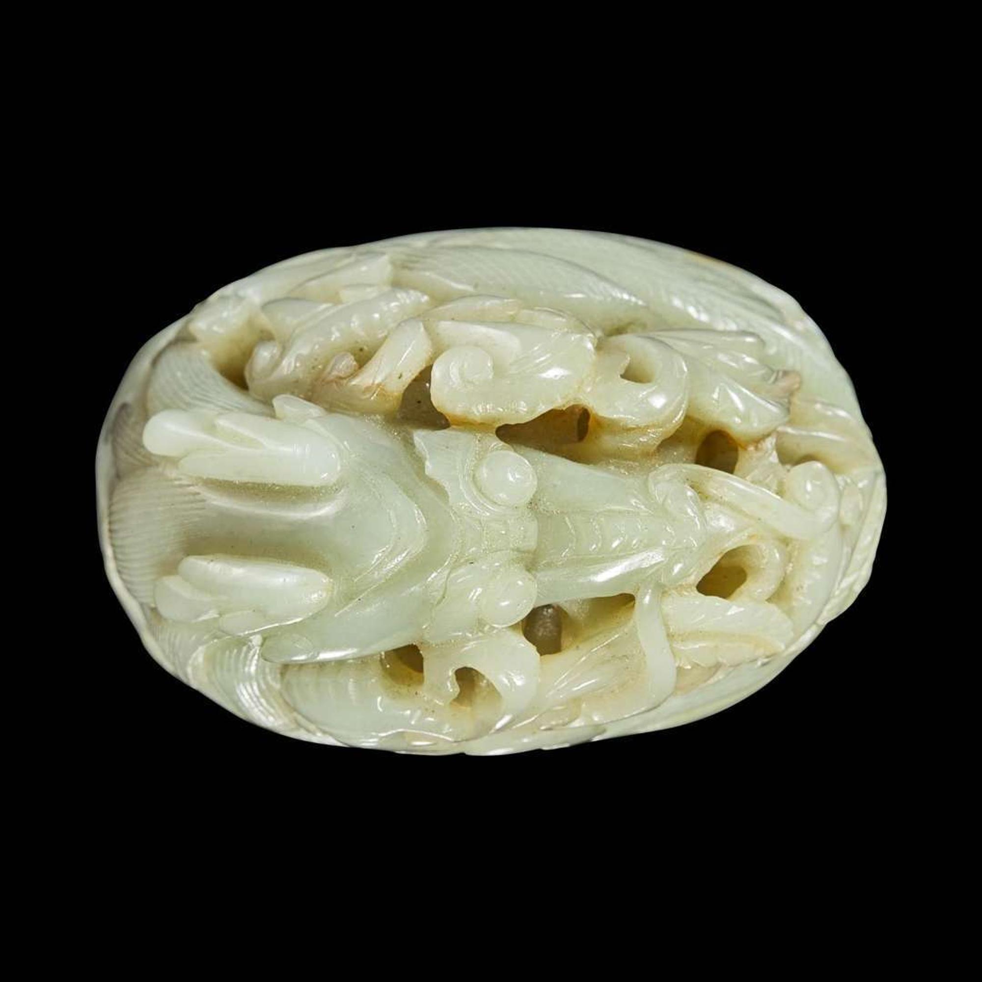 A Chinese pale celadon jade reticulated "Dragon" finial 青白玉镂空龙形炉端