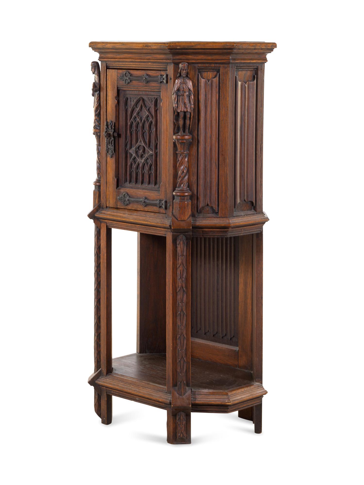 A Gothic Revival Carved Oak Cabinet
