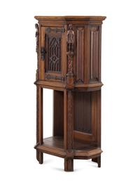 A Gothic Revival Carved Oak Cabinet