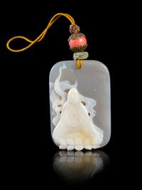 A Carved Agate Pendant Length 2 1/4 x width 1 5/8 inches.