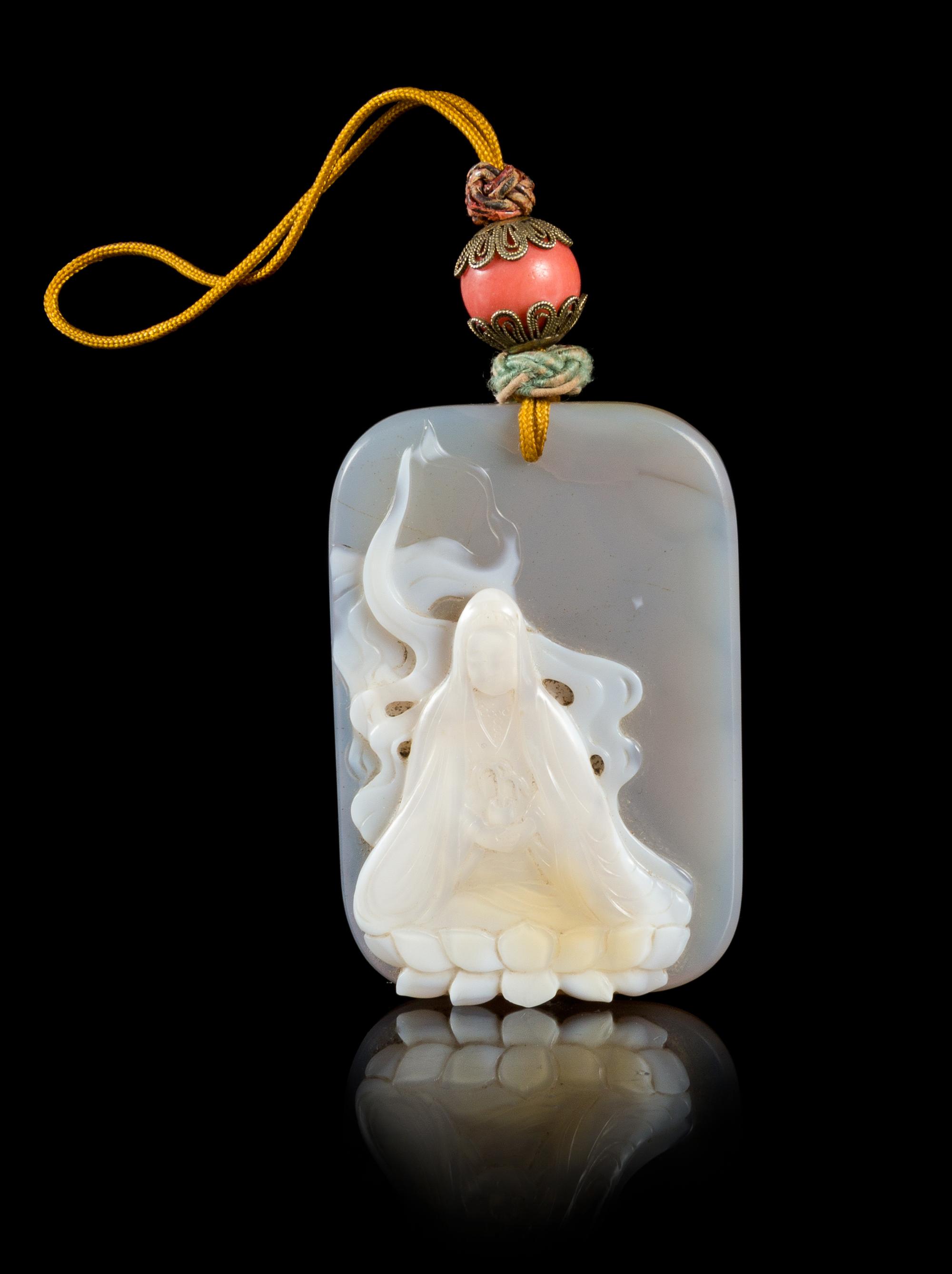 A Carved Agate Pendant Length 2 1/4 x width 1 5/8 inches.