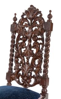 A Set of Ten Jacobean Style Carved Walnut Dining Chairs