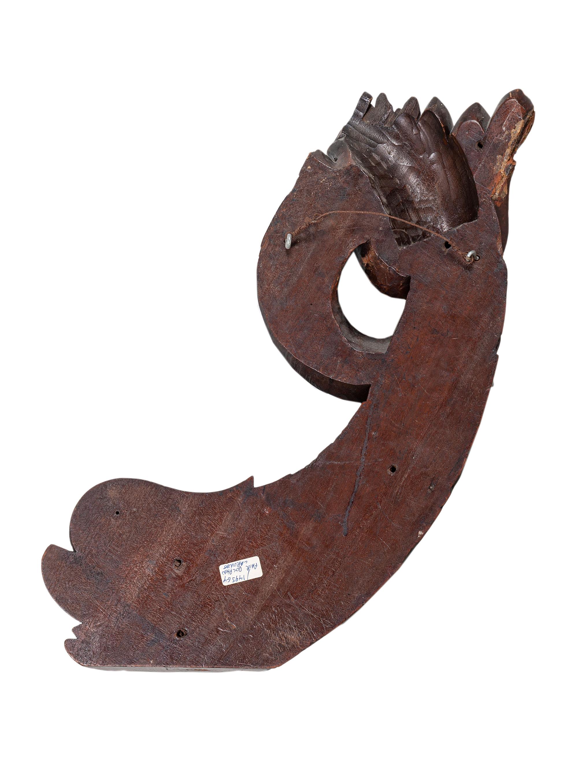 A Pair of Carved Mahogany Dolphin Brackets