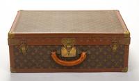 A Louis Vuitton Monogram Canvas Alzer Suitcase, 16" H x 23.5"W x 8.25"D; Handle drop: 2".