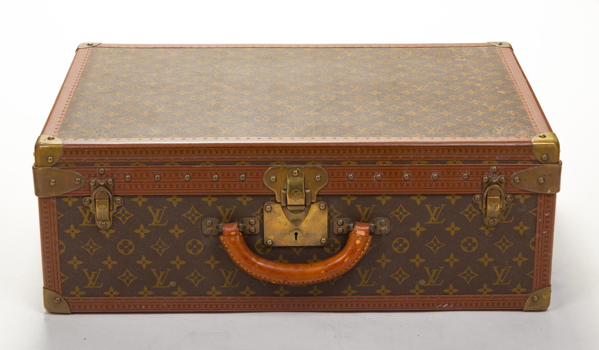 A Louis Vuitton Monogram Canvas Alzer Suitcase, 16" H x 23.5"W x 8.25"D; Handle drop: 2".