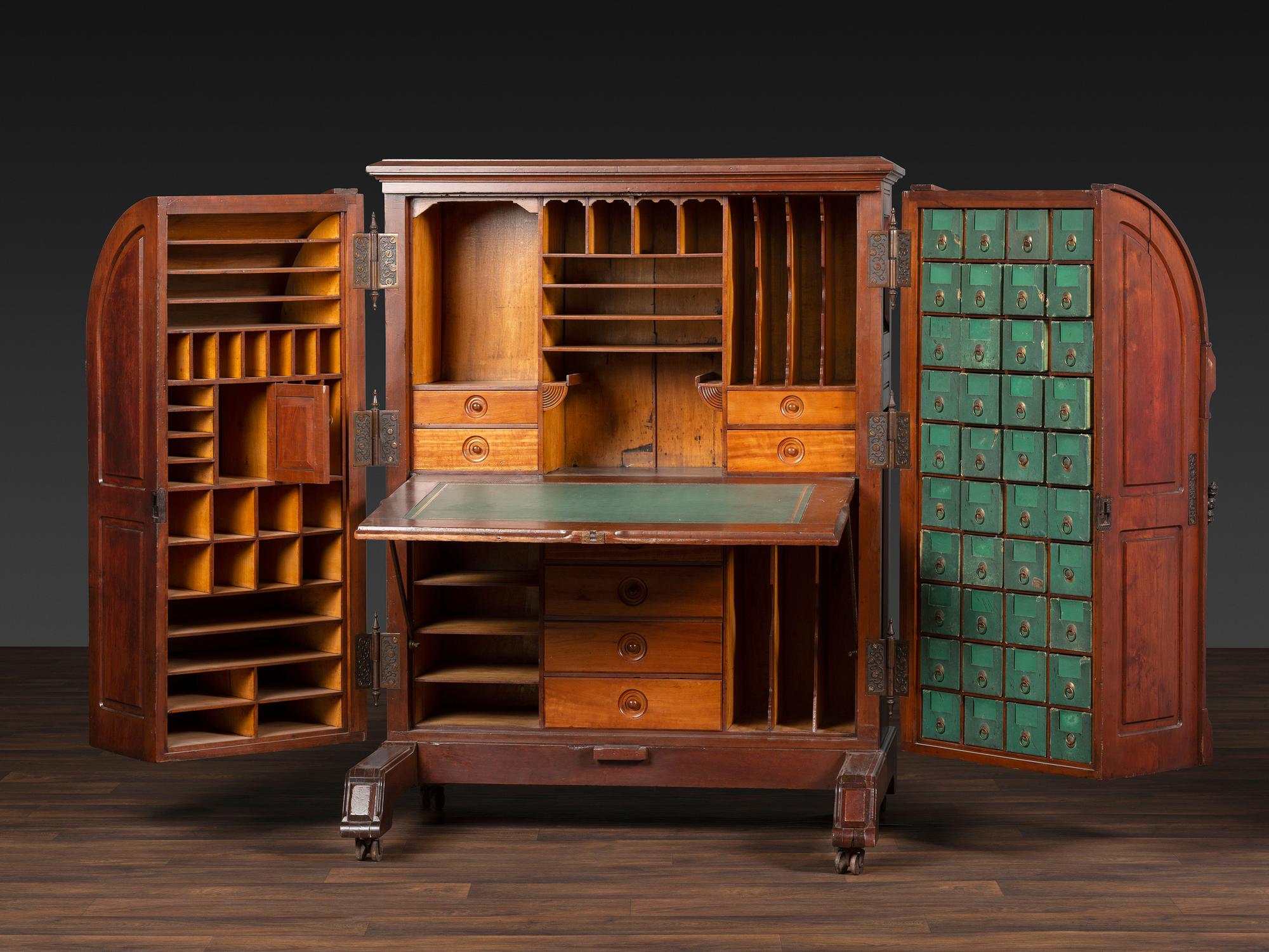 A Carved Walnut Wooton Secretary Desk