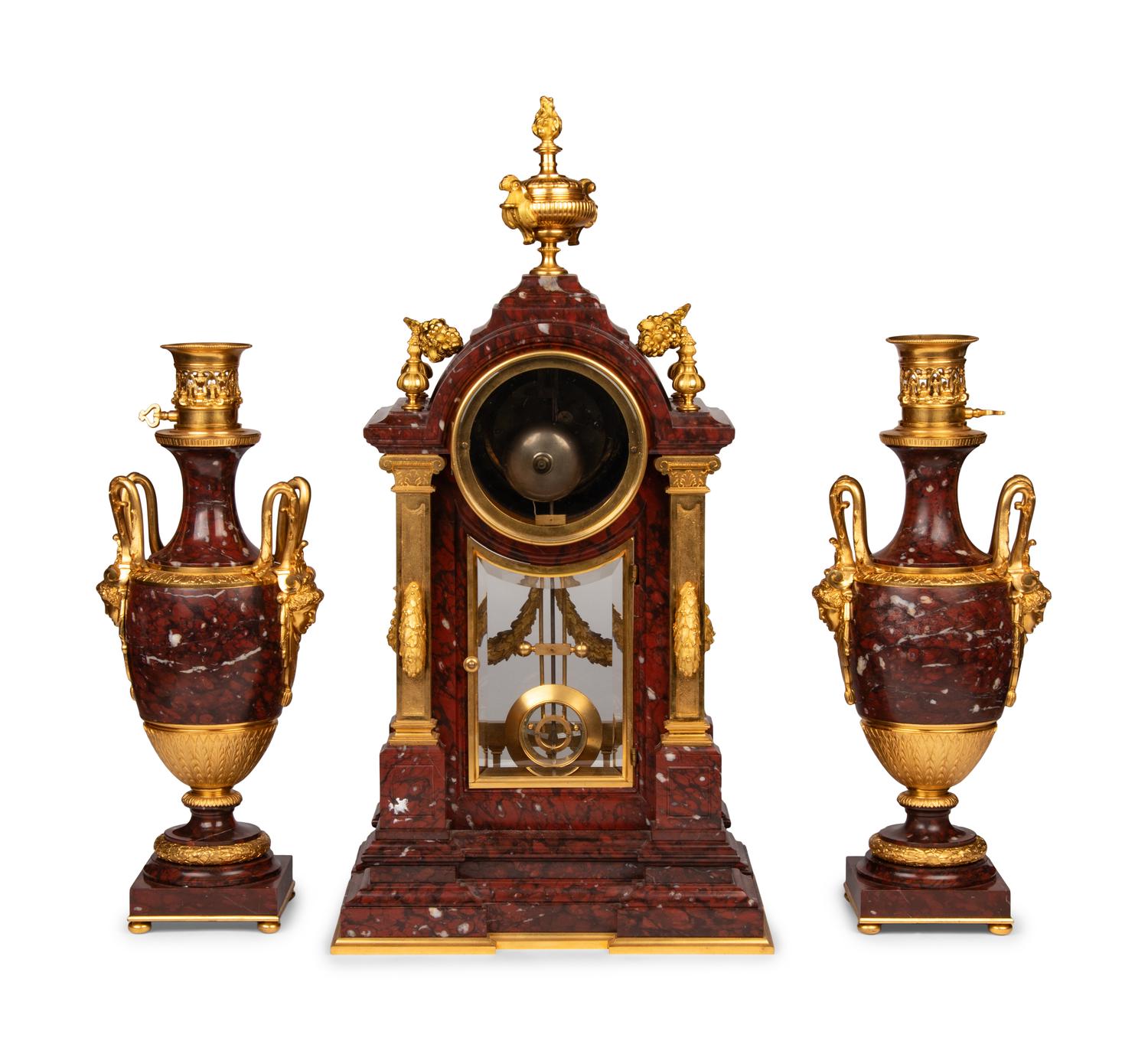 A Louis XVI Style Rouge Marble and Gilt Bronze Clock Garniture