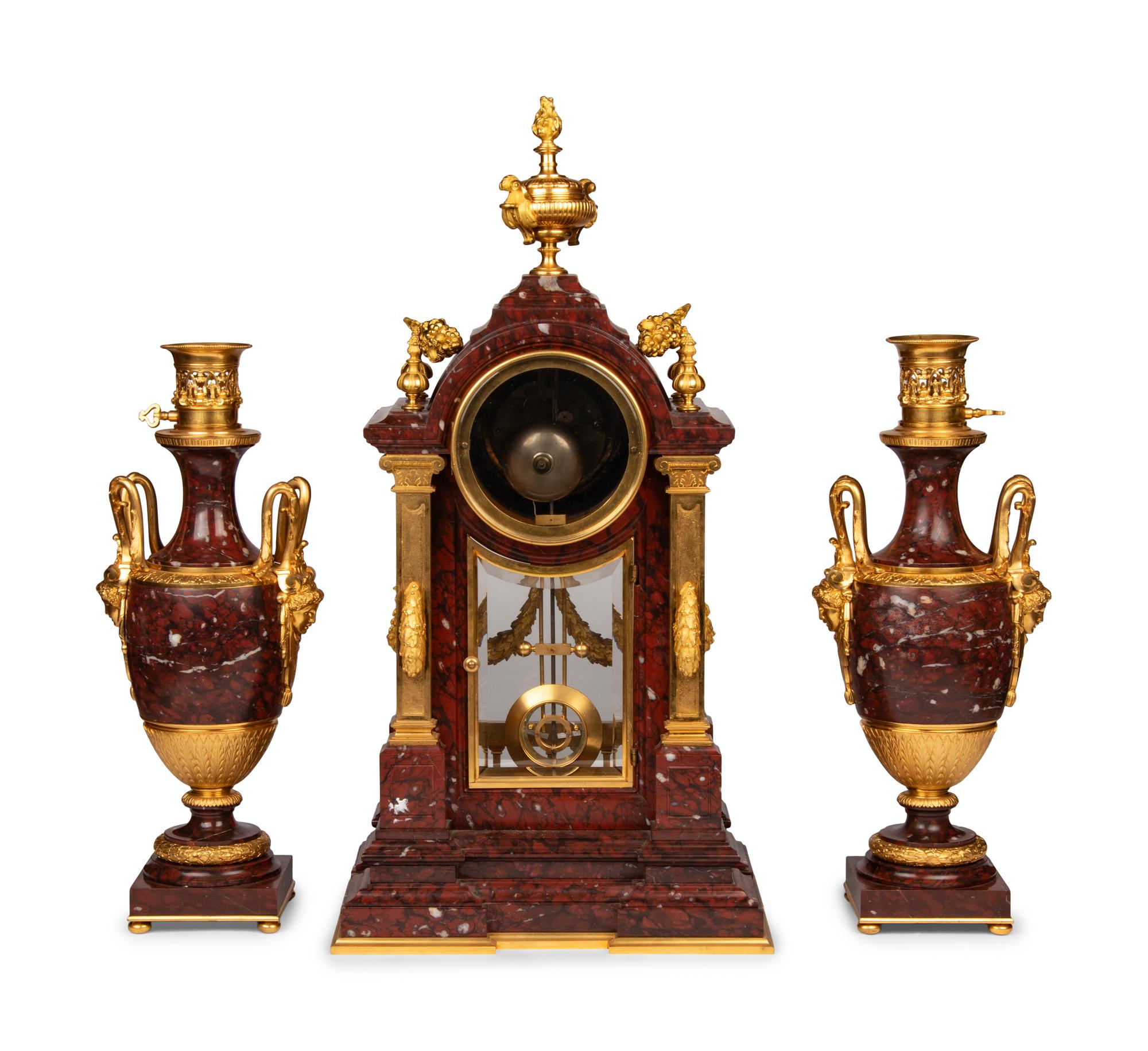 A Louis XVI Style Rouge Marble and Gilt Bronze Clock Garniture