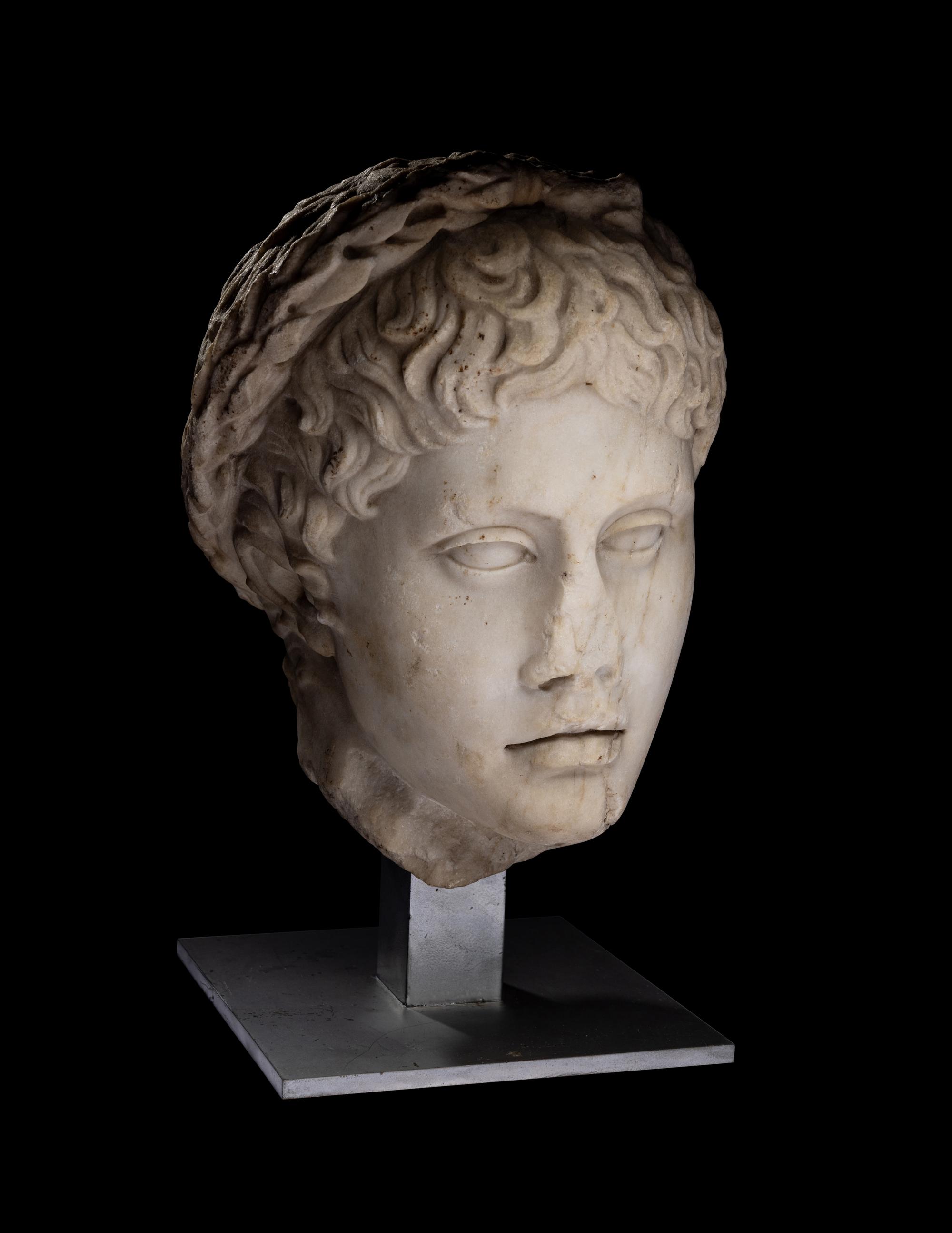 A Roman Marble Head of a Youth Wearing a Laurel Wreath