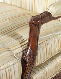 A Pair of Louis XV Style Carved Walnut Fauteuils