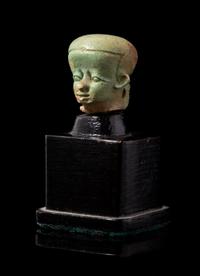 An Egyptian Faience Head of Pataikos Height 3/4 inches. — PTOLEMAIC PERIOD, 304-30 B.C.E.