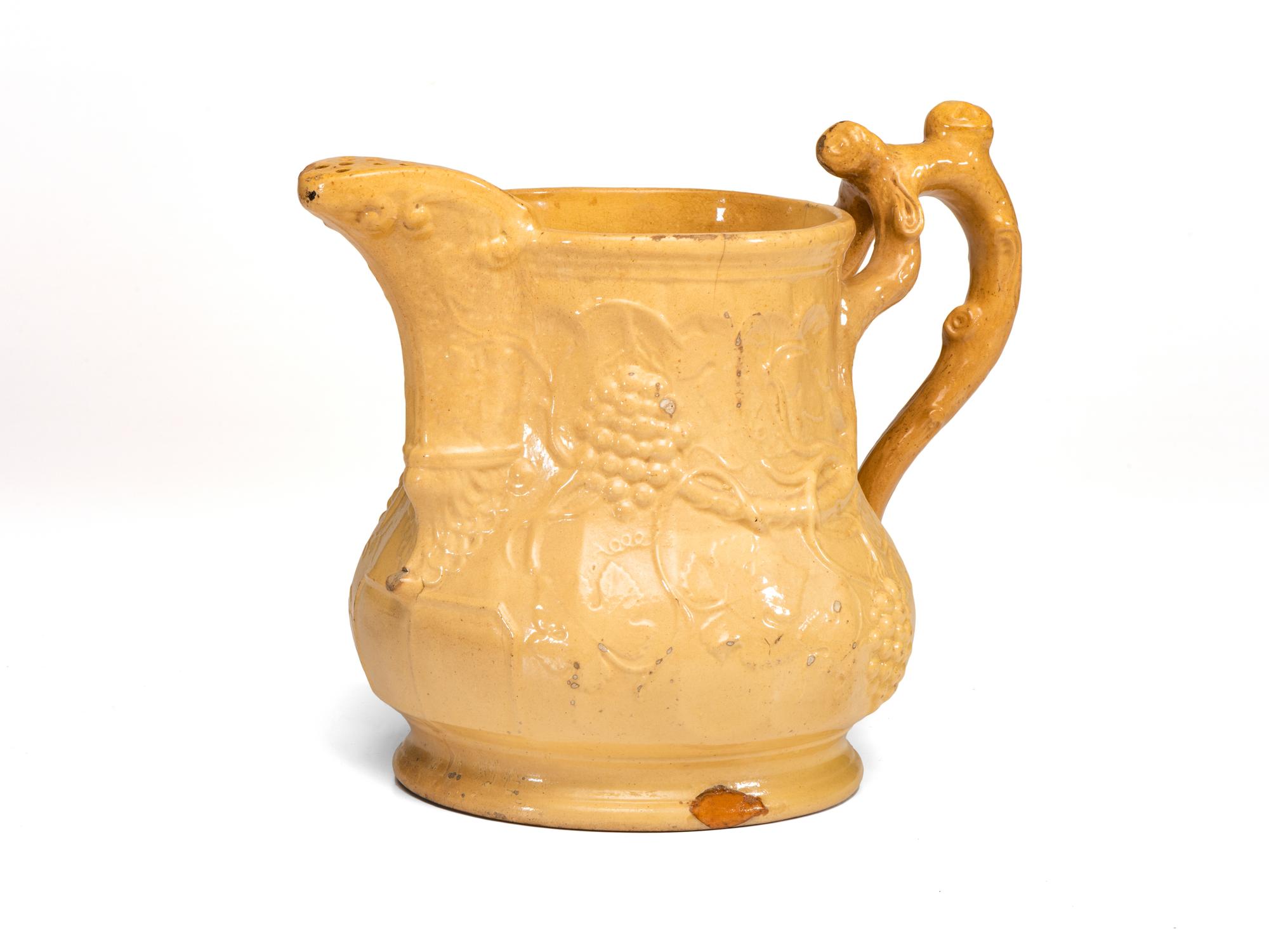 A Large Swan Hill Pottery Molded Yellowware Ice Water Pitcher