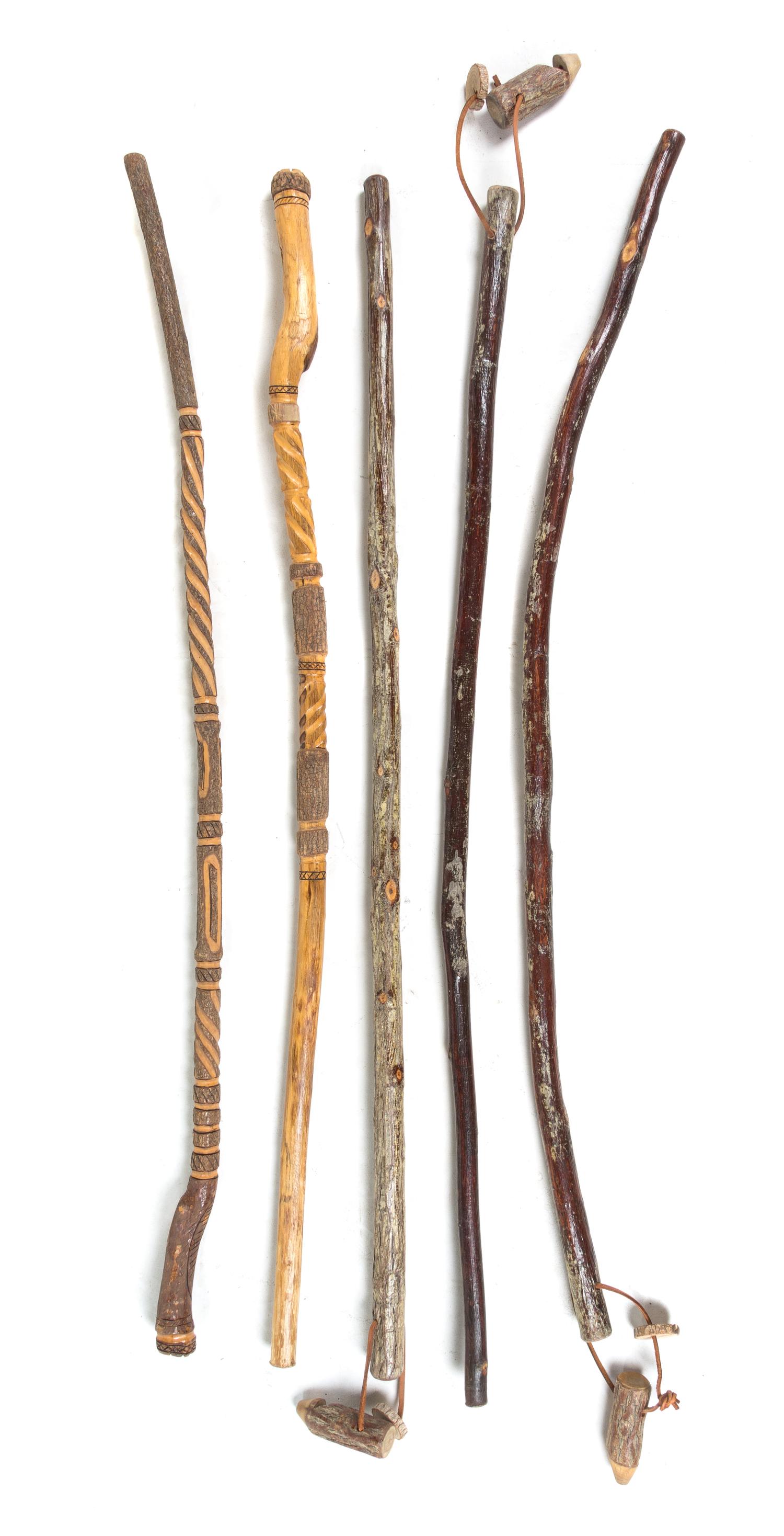 A Group of Five Walking Sticks Length of longest 54 inches.