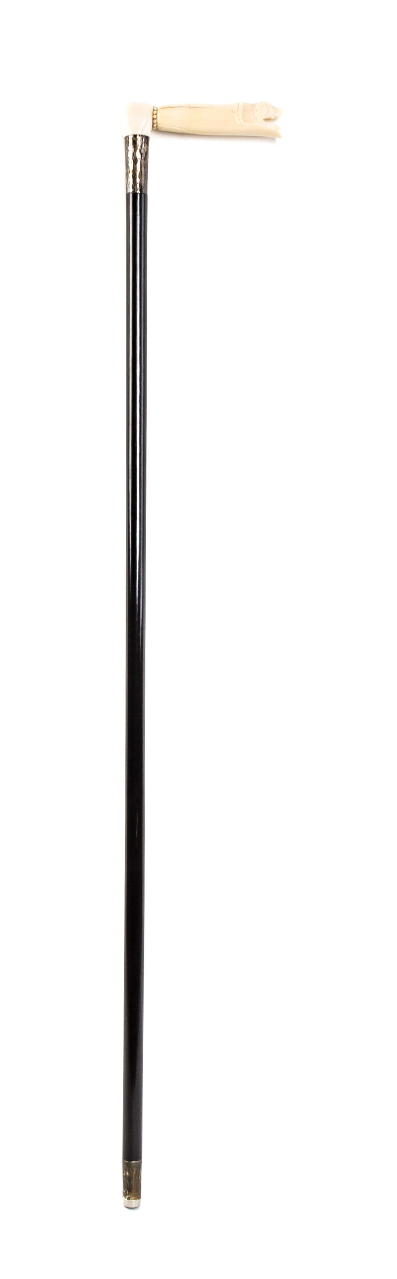 An American Walrus Ivory Handled Cane, Length of handle 5 1/4 x length overall 35 5/8 inches.