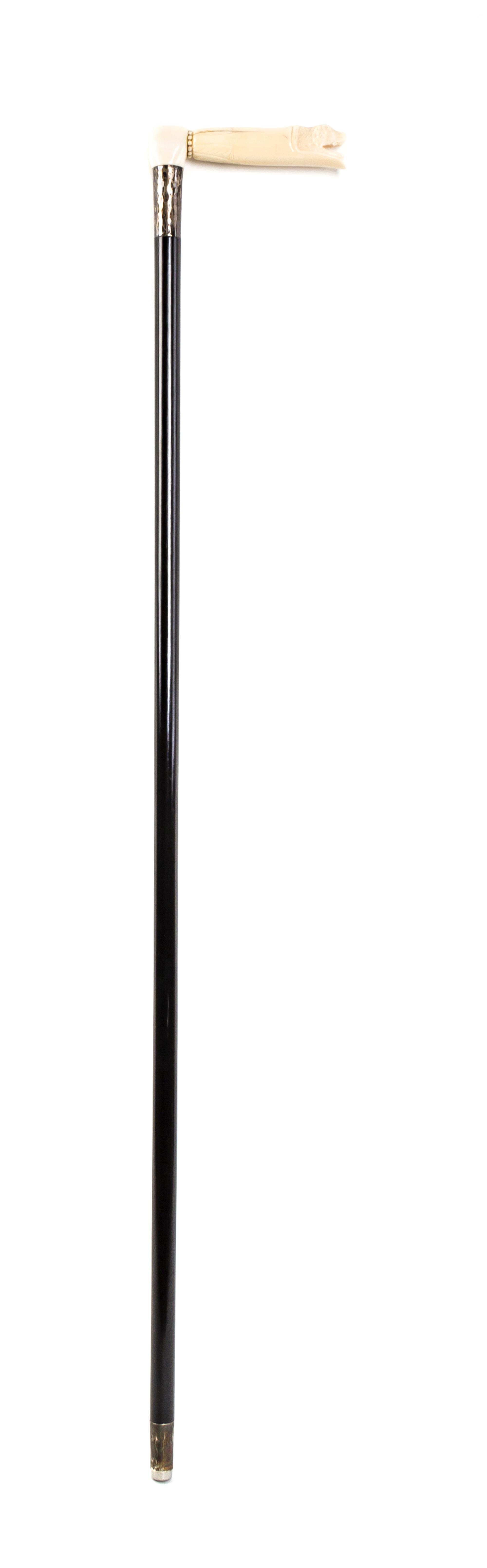 An American Walrus Ivory Handled Cane, Length of handle 5 1/4 x length overall 35 5/8 inches.