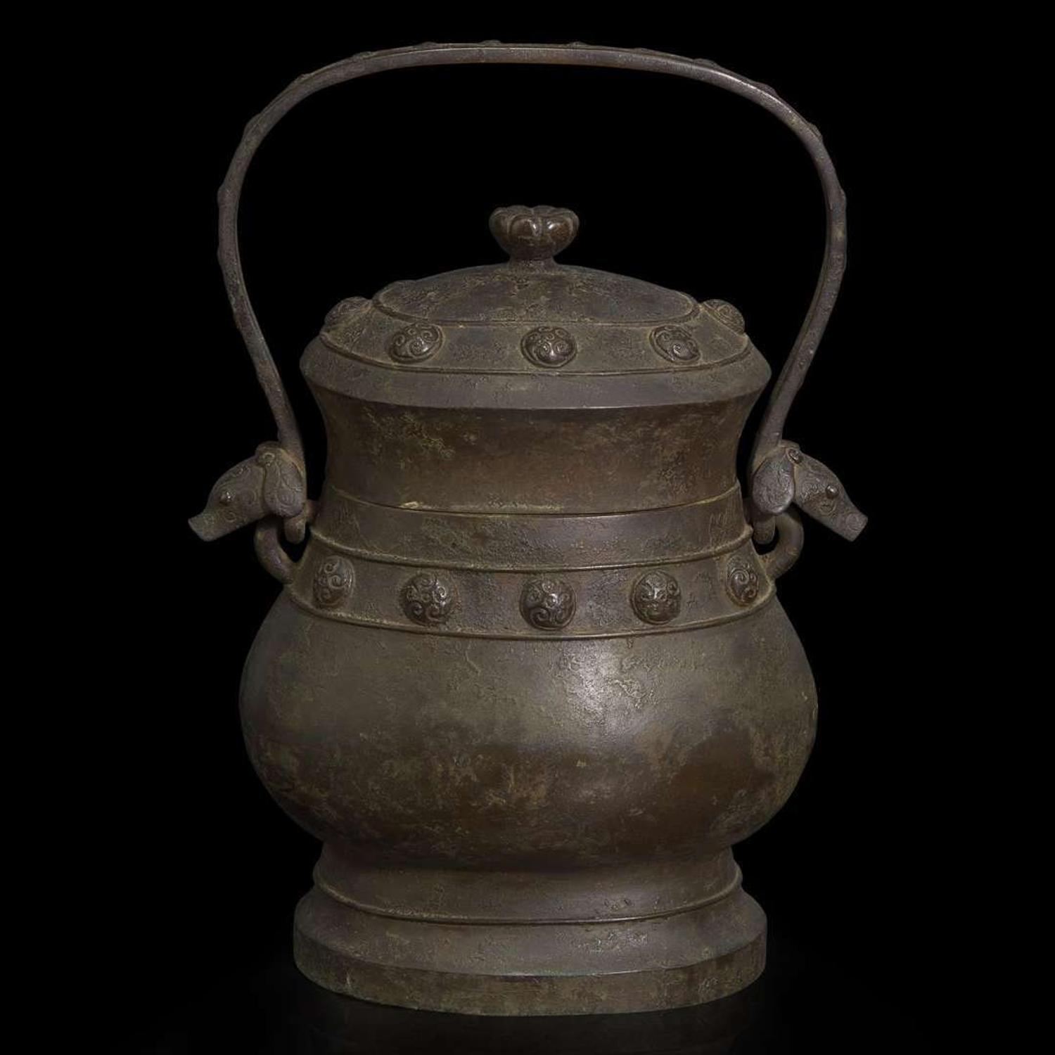 A Chinese patinated bronze archaistic vessel and cover, you 复古风格铜提梁卣