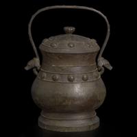 A Chinese patinated bronze archaistic vessel and cover, you 复古风格铜提梁卣
