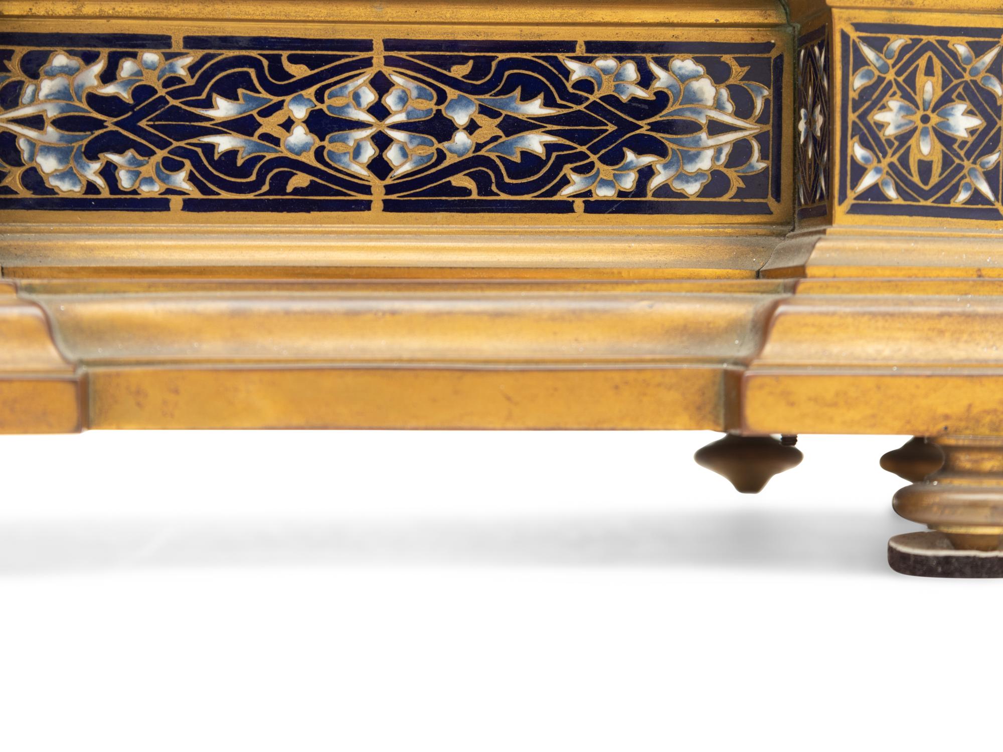 A French Gilt Bronze and Enamel Clock Garniture