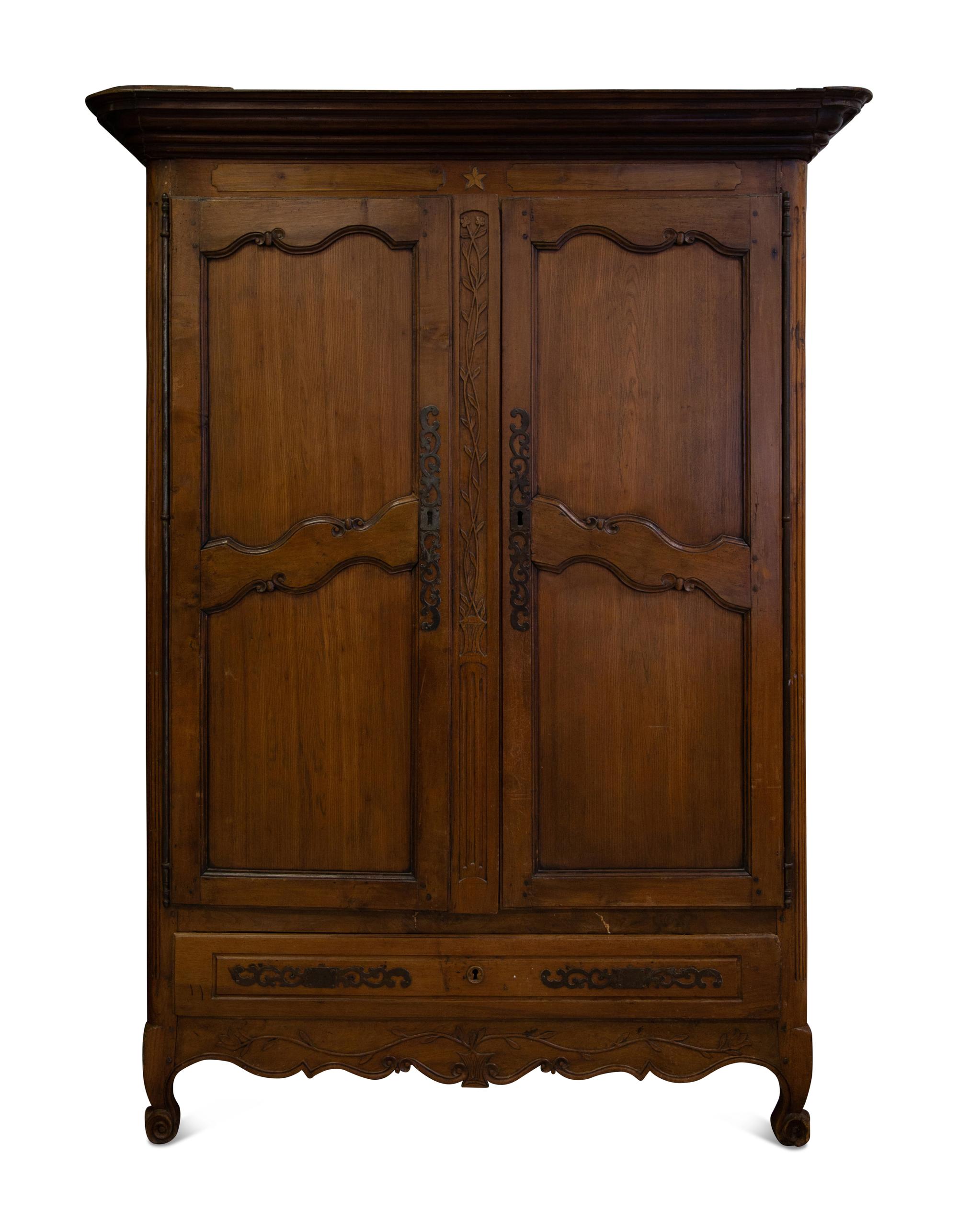 A French Provincial Carved Walnut Armoire