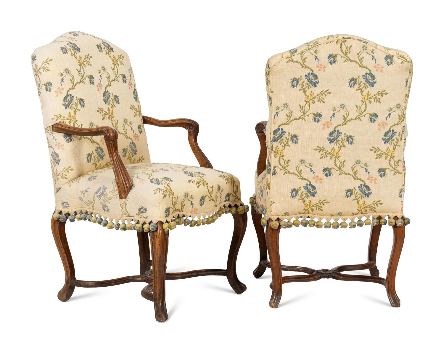 A Pair of Régence Walnut Open Armchairs