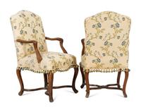 A Pair of Régence Walnut Open Armchairs
