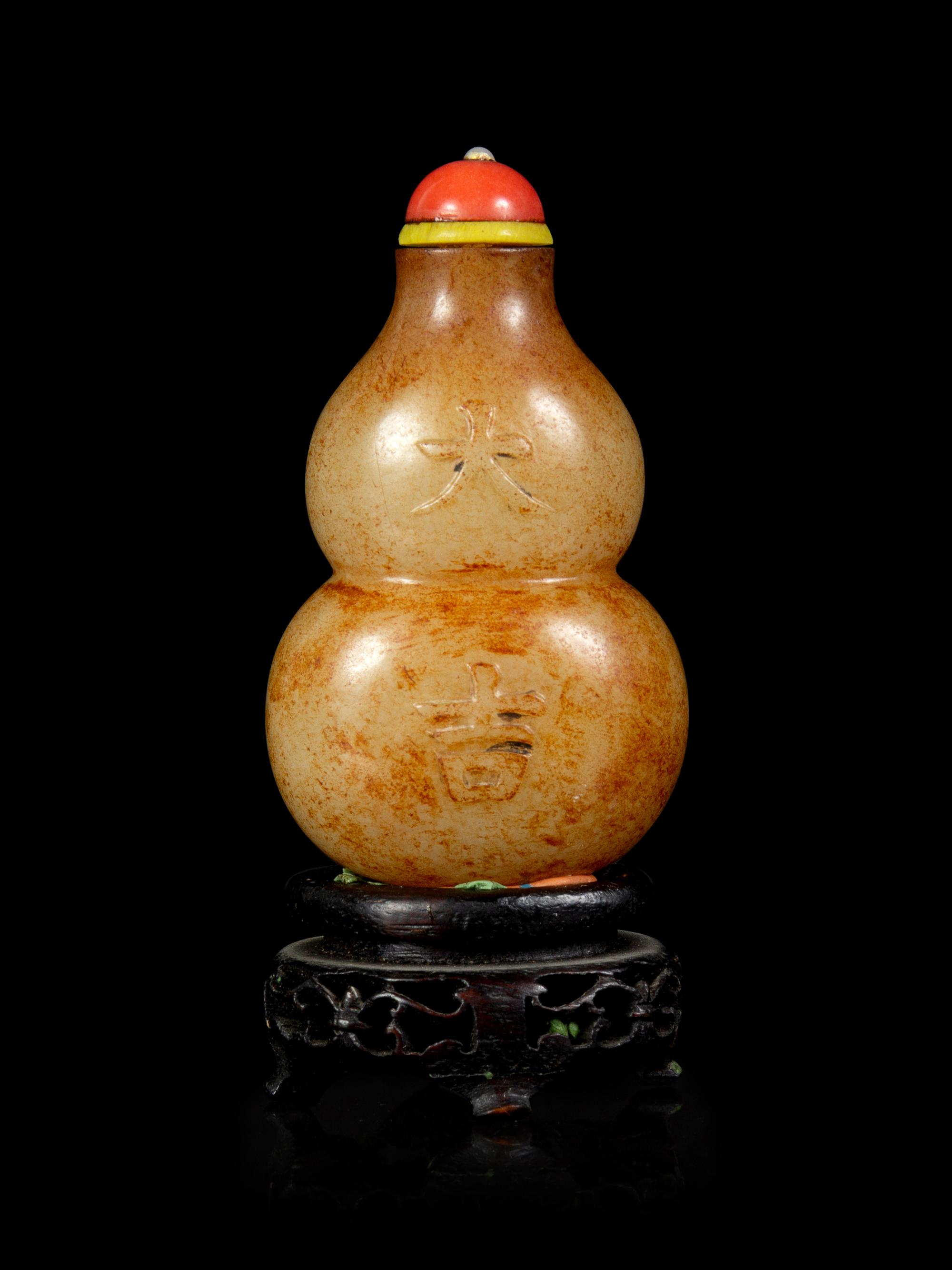 A Russet and Celadon Jade Double-Gourd Form Snuff Bottle