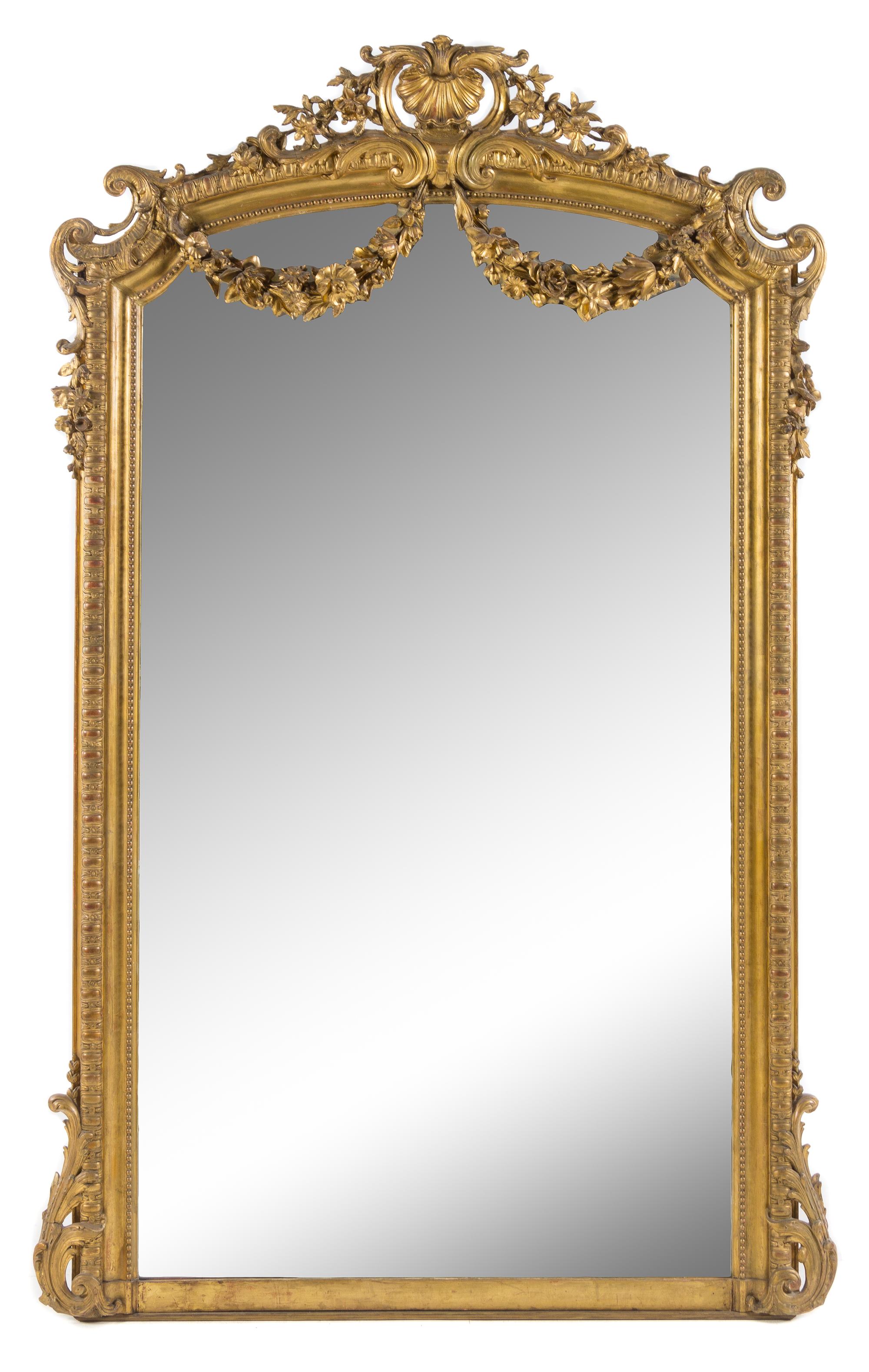 A Napoleon III Giltwood Overmantel Mirror Height 82 1/2 x width 51 inches. — 19TH CENTURY