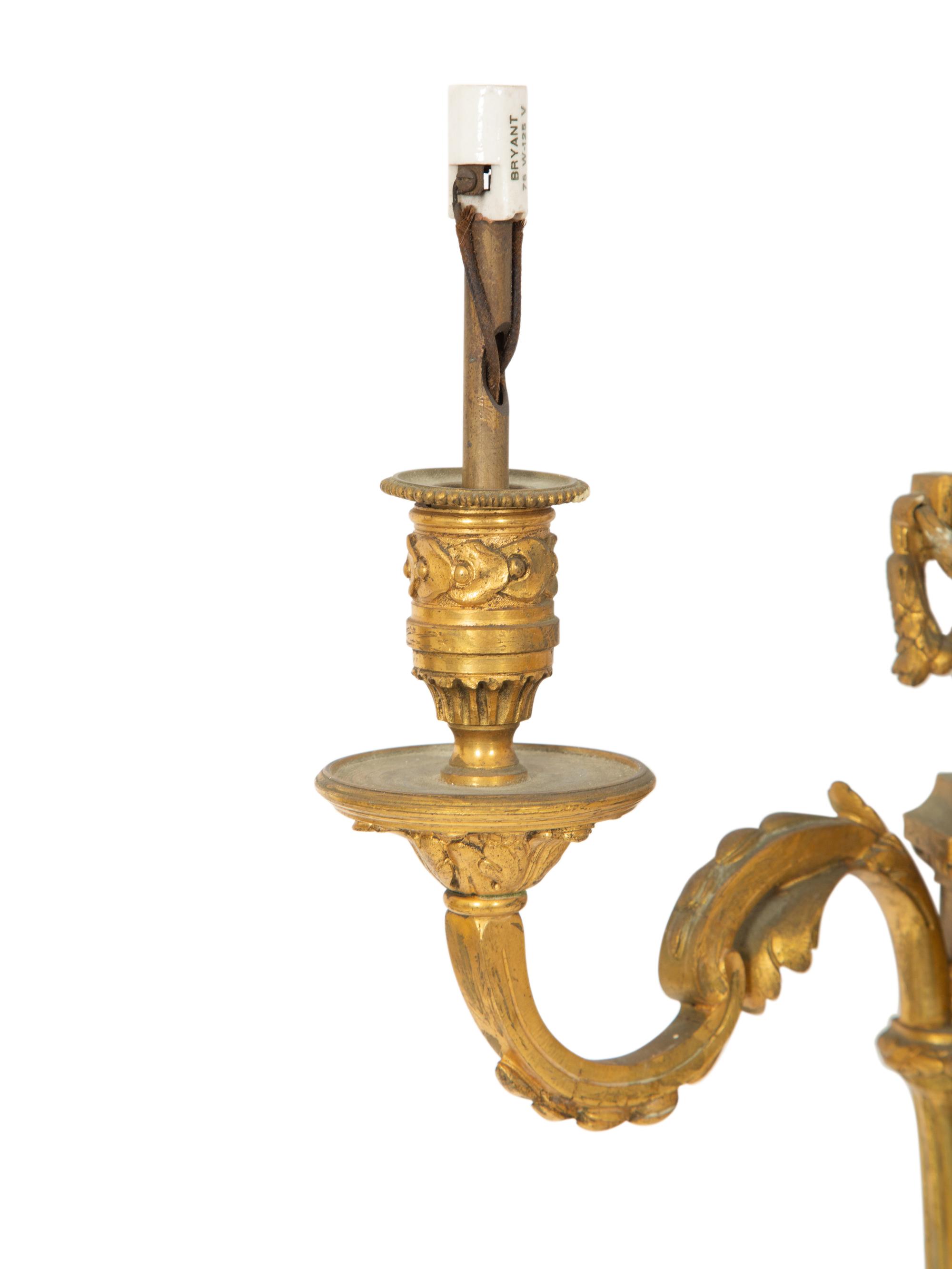 A Pair of Louis XVI Style Gilt Bronze Three-Light Wall Sconces