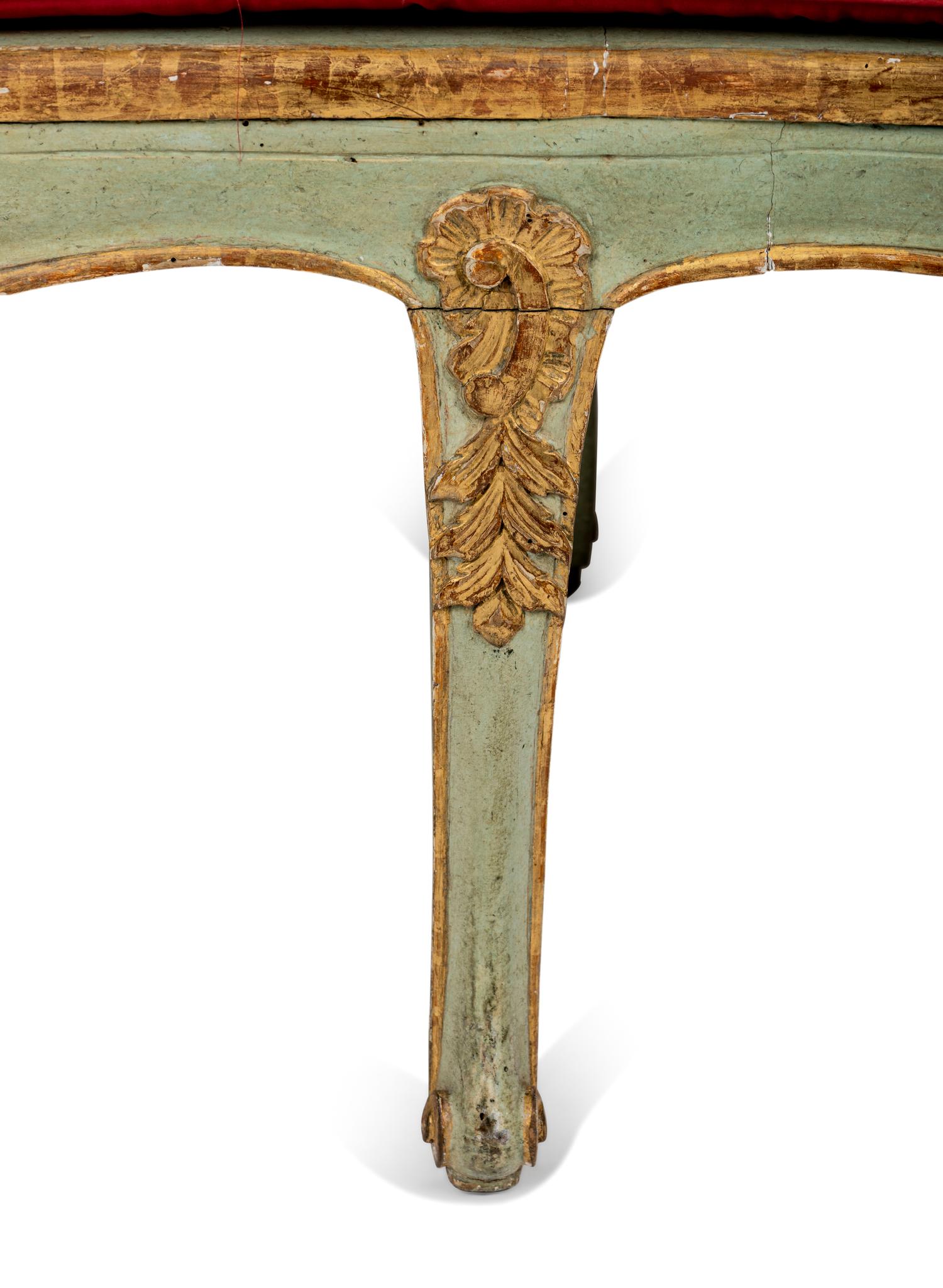 A Pair of Louis XV Green-Painted and Parcel-Gilt Cane Seat Window Benches