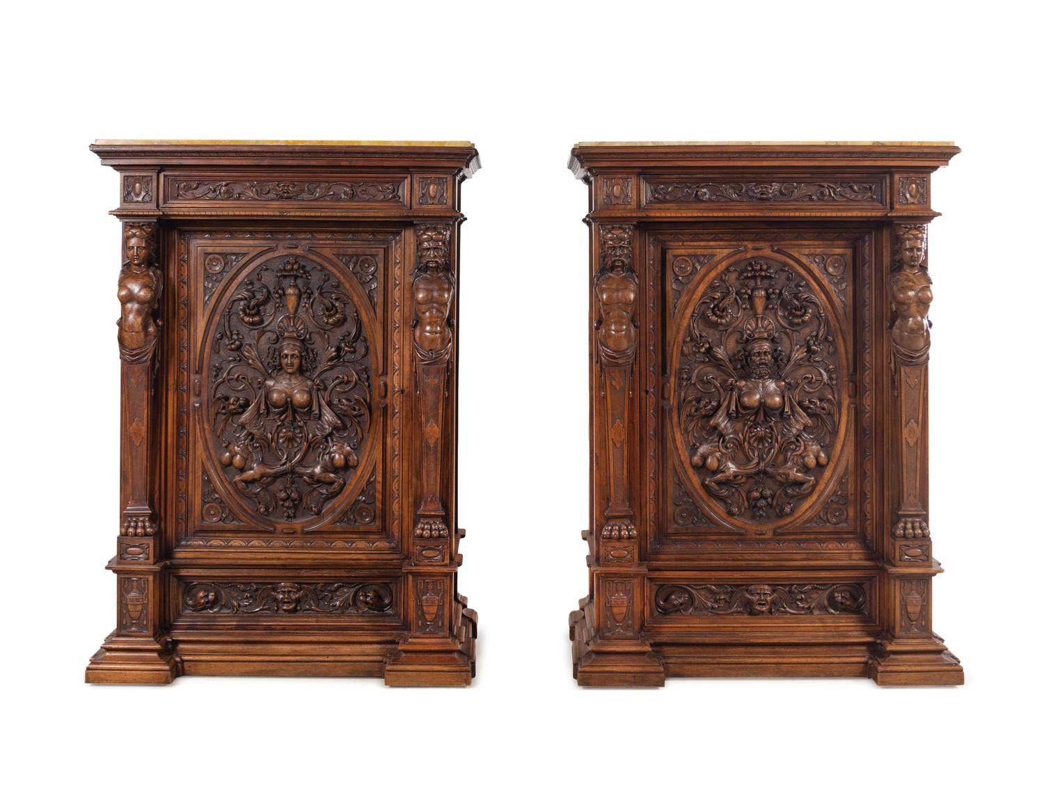 A Pair of Renaissance Revival Carved Walnut Marble-Top Cabinets